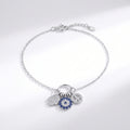 Silver bracelet with charms on a light gray background